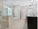 Modern bathroom with glass-enclosed shower, soaking tub, and double vanity at 4884 Kentwood Dr, Marietta, GA 30068