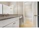 Bathroom with white vanity, granite countertops, white cabinets, and neutral colored tiles at 4884 Kentwood Dr, Marietta, GA 30068