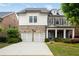 Charming two-story home featuring a brick and siding facade, a two-car garage, and a well-manicured front lawn at 4884 Kentwood Dr, Marietta, GA 30068