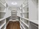 Large walk-in closet with custom shelving and hardwood floors at 4884 Kentwood Dr, Marietta, GA 30068