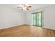 Bedroom featuring wood-look floors, a ceiling fan, and a sliding glass door providing natural light at 228 Smokerise Se Cir, Marietta, GA 30067