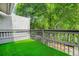 Cozy outdoor patio area with artificial turf for low maintenance and a relaxing outdoor space at 228 Smokerise Se Cir, Marietta, GA 30067