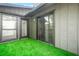 Inviting patio area with artificial turf, sliding glass doors, offering a seamless transition indoors at 228 Smokerise Se Cir, Marietta, GA 30067