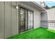 Inviting patio area with artificial turf, sliding glass doors, offering a seamless transition indoors at 228 Smokerise Se Cir, Marietta, GA 30067