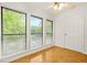 Bright sunroom featuring wood-look floors, a ceiling fan, and expansive windows offering verdant outdoor views at 228 Smokerise Se Cir, Marietta, GA 30067