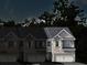 A nighttime view of newly constructed townhomes in a residential neighborhood at 3031 Greyton Dr, Buford, GA 30519
