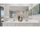 Bright bathroom with double vanity, large mirror, and shower with glass doors at 3041 Greyton Dr, Buford, GA 30519