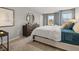 Bright bedroom featuring a large bed, dresser with a round mirror, and neutral decor at 3041 Greyton Dr, Buford, GA 30519