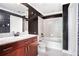 Cozy bathroom featuring a tub-shower combination, granite countertop, and unique wallpaper accents at 361 17Th Nw St # 2407, Atlanta, GA 30363