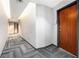 Condo hallway with neutral toned walls, patterned carpeting, and wooden entry door at 361 17Th Nw St # 2407, Atlanta, GA 30363