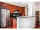 Modern kitchen boasts stainless steel appliances, granite countertops, and cherry cabinets at 361 17Th Nw St # 2407, Atlanta, GA 30363
