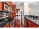 Modern kitchen boasts stainless steel appliances, granite countertops, and cherry cabinets at 361 17Th Nw St # 2407, Atlanta, GA 30363
