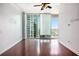 Bright living room features hardwood floors and floor-to-ceiling windows with a city view at 361 17Th Nw St # 2407, Atlanta, GA 30363
