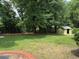 Spacious backyard with lush greenery, shade trees and storage shed at 2190 Olive Springs Se Rd, Marietta, GA 30060