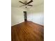 Well-lit bedroom features hardwood floors, a ceiling fan, and a spacious closet at 2190 Olive Springs Se Rd, Marietta, GA 30060