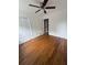 Well-lit bedroom features hardwood floors, a ceiling fan, and a spacious closet at 2190 Olive Springs Se Rd, Marietta, GA 30060