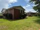 Cozy brick house featuring a green lawn and mature landscaping at 2190 Olive Springs Se Rd, Marietta, GA 30060