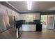 Modern kitchen featuring stainless steel appliances, sleek black countertops, and bright white cabinetry at 2190 Olive Springs Se Rd, Marietta, GA 30060