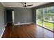 Inviting living room with hardwood floors, large windows, and modern ceiling fan at 2190 Olive Springs Se Rd, Marietta, GA 30060
