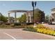 Inviting market village entrance with flowers and shops, creating a vibrant community space at 2190 Olive Springs Se Rd, Marietta, GA 30060