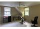 Spacious bedroom area with windows, and ceiling fan, offering a comfortable workspace and view at 2413 Charleston Oaks Ln, Decatur, GA 30030