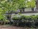 Charming two-story home with a wooden deck and lush greenery, providing a private and serene outdoor space at 2413 Charleston Oaks Ln, Decatur, GA 30030