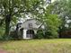 Quaint two-story home exterior featuring a screened-in porch and mature trees at 2413 Charleston Oaks Ln, Decatur, GA 30030