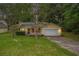Charming single-Gathering home with yellow siding, red shutters, well-maintained lawn, and attached garage at 2631 Rolling Hills Way, Conyers, GA 30094