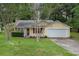 Charming single-Gathering home with yellow siding, red shutters, well-maintained lawn, and attached garage at 2631 Rolling Hills Way, Conyers, GA 30094