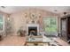 Elegant living room with a fireplace, hardwood floors, ample lighting, and stylish decor at 2631 Rolling Hills Way, Conyers, GA 30094