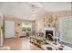 Elegant living room with a fireplace, hardwood floors, ample lighting, and stylish decor at 2631 Rolling Hills Way, Conyers, GA 30094