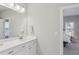 This bathroom features a large mirror, white vanity with marble countertop, and an open doorway to the bedroom at 3332 Old Concord Se Rd, Smyrna, GA 30082