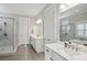 Bright bathroom with double vanity, large mirrors, and a separate glass-enclosed shower at 3332 Old Concord Se Rd, Smyrna, GA 30082