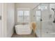 Bright bathroom featuring a soaking tub and glass-enclosed shower at 3332 Old Concord Se Rd, Smyrna, GA 30082