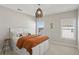 This bedroom features a stylish woven light fixture, two windows, neutral colors, and a bed with built-in drawers at 3332 Old Concord Se Rd, Smyrna, GA 30082
