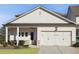 Charming single story home featuring a two car garage, white siding, covered porch, and well manicured lawn at 3332 Old Concord Se Rd, Smyrna, GA 30082