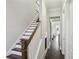 Hallway view of staircase with wood treads, white risers and dark hardwood floors at 3332 Old Concord Se Rd, Smyrna, GA 30082