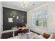 Stylish home office with statement wall, a large window, and hardwood floors at 3332 Old Concord Se Rd, Smyrna, GA 30082