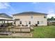 Large backyard featuring a patio with built-in grill, volleyball net, and grassy area at 4699 Price St, Forest Park, GA 30297