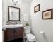 Bathroom featuring a toilet and a sink with brown wood cabinets at 4699 Price St, Forest Park, GA 30297