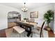 Formal dining room with chandelier, neutral colors, and an open archway to the kitchen at 4699 Price St, Forest Park, GA 30297