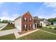 Charming two-story brick home with a well-manicured lawn and a two-car garage in a quiet neighborhood at 4699 Price St, Forest Park, GA 30297