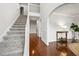 Inviting foyer with hardwood floors, staircase, archways and elegant white trim at 4699 Price St, Forest Park, GA 30297