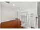 Well-lit hallway features hardwood floors, white railing stairs and view of the front door at 4699 Price St, Forest Park, GA 30297