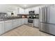 Contemporary kitchen with stainless steel appliances, light gray cabinets, and modern backsplash at 4699 Price St, Forest Park, GA 30297