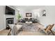 Bright living room showcases fireplace, modern furniture, stylish decor, and wood-look tile flooring at 4699 Price St, Forest Park, GA 30297