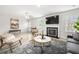 Inviting living room features fireplace, modern decor, wood-look tile flooring, and lots of natural light at 4699 Price St, Forest Park, GA 30297