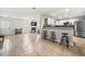 Open living room boasts fireplace, bar seating and island connecting to kitchen with stainless appliances at 4699 Price St, Forest Park, GA 30297