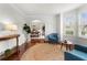 Cozy living room features hardwood floors, neutral colors, and an open archway to the dining area at 4699 Price St, Forest Park, GA 30297
