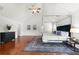Bright main bedroom with a four poster bed and dark wood floors at 4699 Price St, Forest Park, GA 30297